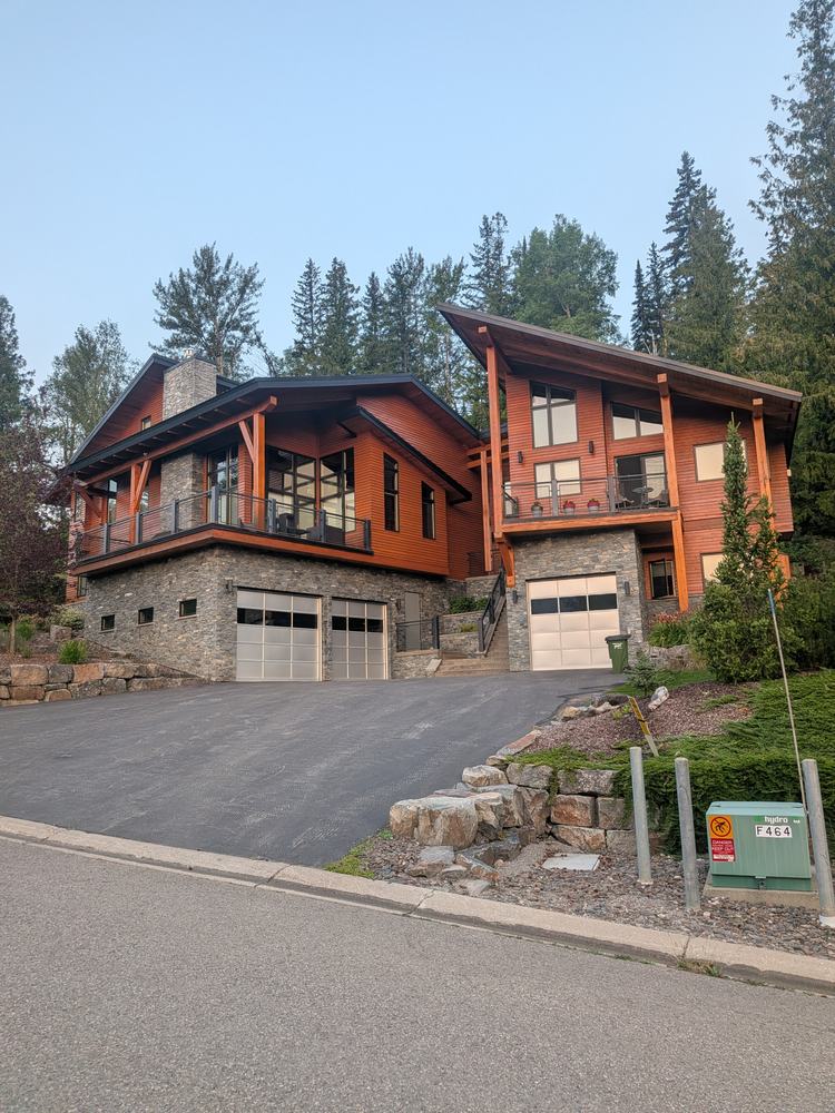 The same two homes finished, with fresh stained siding